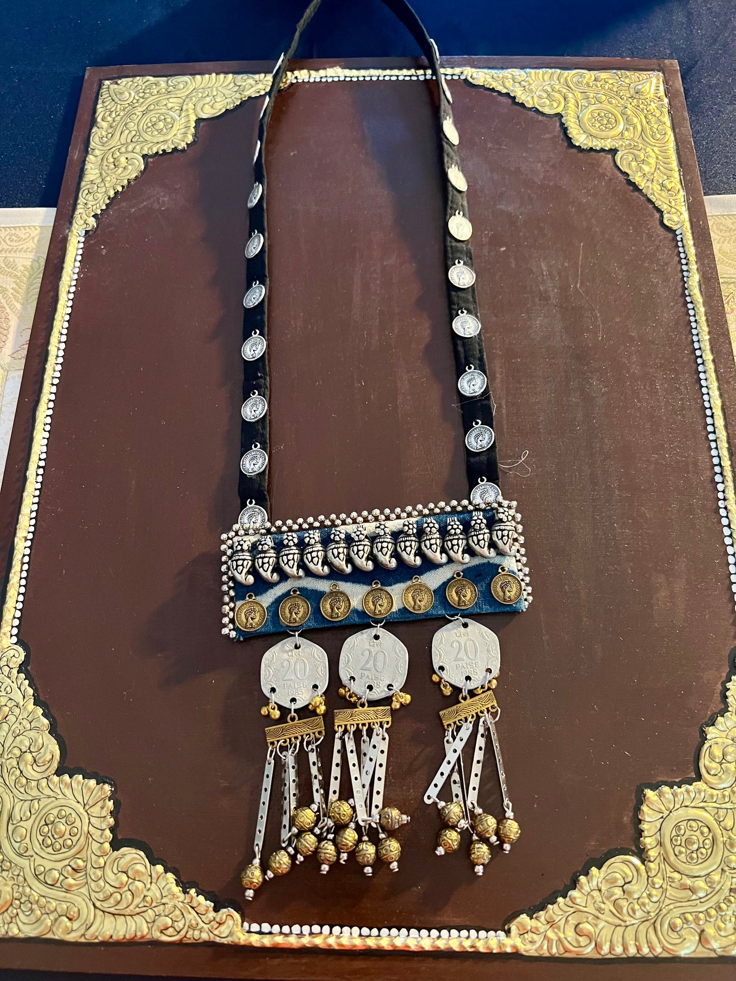 Handcrafted upcycled coin necklaces, featuring unique, vintage coins and intricate detailing, offering a blend of sustainability and timeless style.