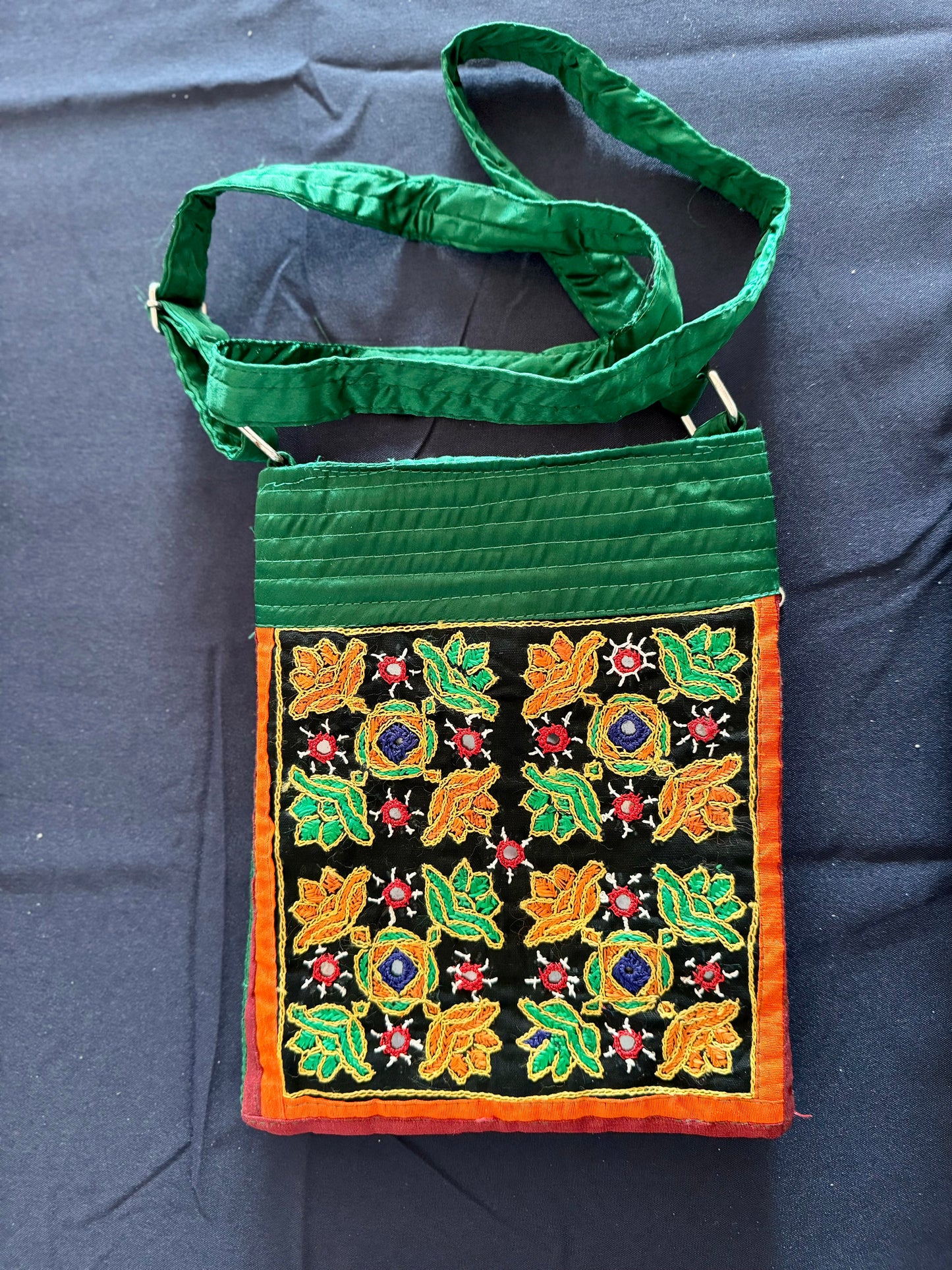 Handcrafted Kutchi embroidery bags and purses featuring intricate needlework, vibrant patterns, and traditional Indian craftsmanship.