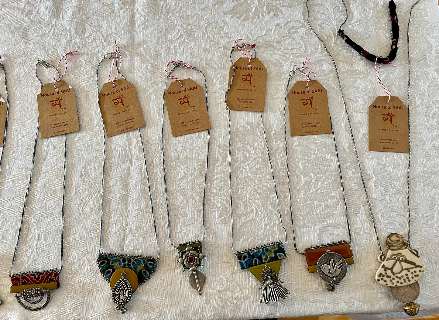 Eco-friendly upcycled handmade small-sized pendant necklaces, featuring delicate designs and sustainable materials, offering a subtle and stylish accessory.