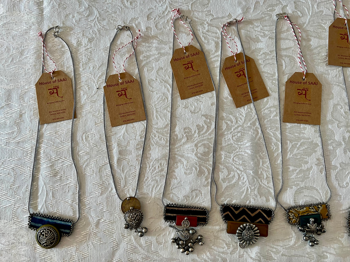 Eco-friendly upcycled handmade small-sized pendant necklaces, featuring delicate designs and sustainable materials, offering a subtle and stylish accessory.