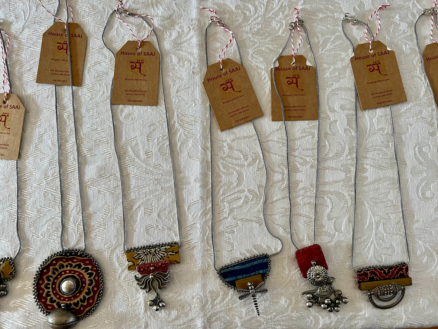 Eco-friendly upcycled handmade small-sized pendant necklaces, featuring delicate designs and sustainable materials, offering a subtle and stylish accessory.