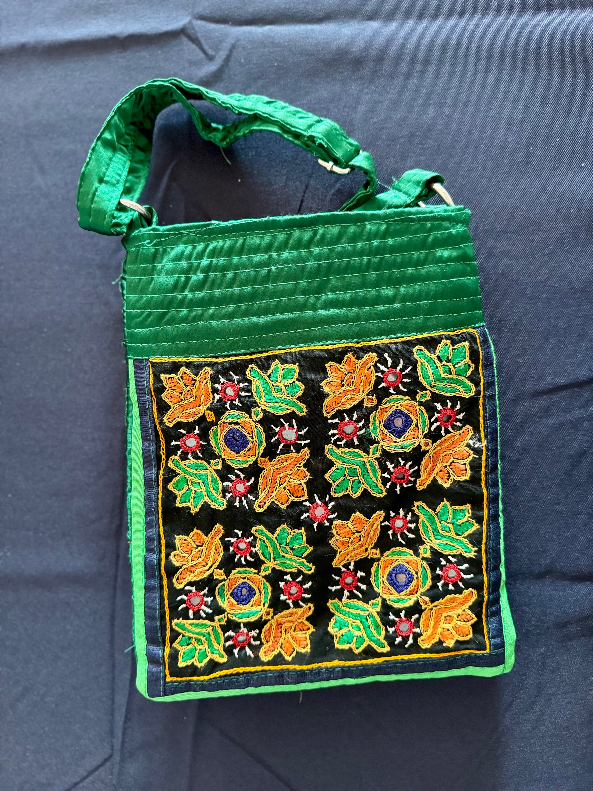 Handcrafted Kutchi embroidery bags and purses featuring intricate needlework, vibrant patterns, and traditional Indian craftsmanship.