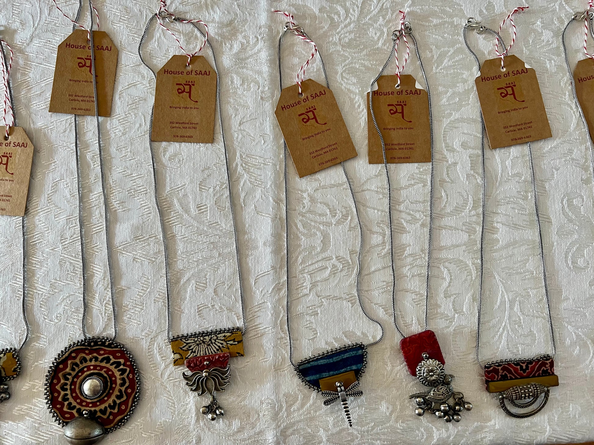 Eco-friendly upcycled handmade small-sized pendant necklaces, featuring delicate designs and sustainable materials, offering a subtle and stylish accessory.